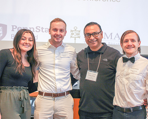 Dr. Habibul Bakht poses with three Hilbert students who presented their Biology poster presentations. 