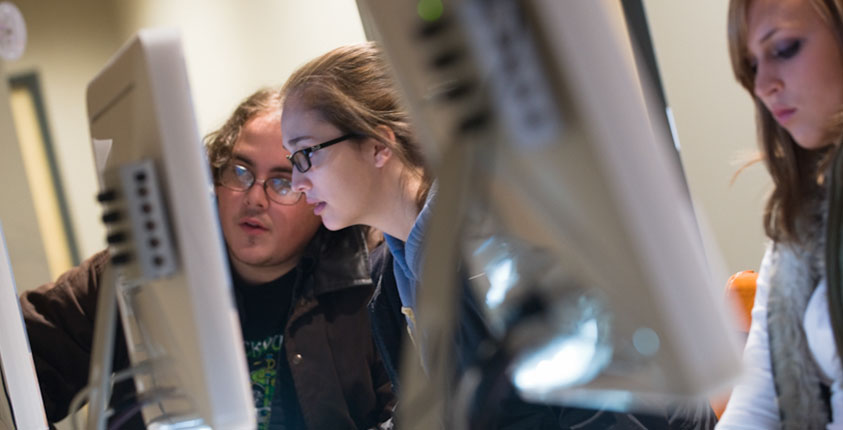 Students learning in Hilbert College's computer lab. 