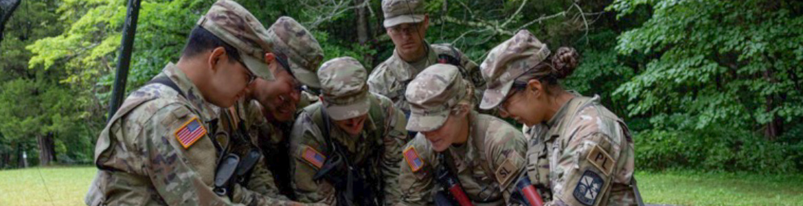 ROTC officers work on training in the woods.