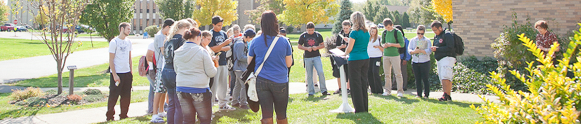 Students gathered around at Hilbert campus to hear a speaker. 