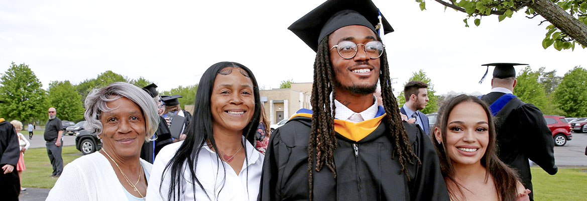 Hilbert graduation image with graduate and family. 