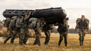 Army ROTC members carrying a boat.