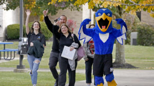 Hilbert campus walks around campus with Bert, our Hawk Mascot.