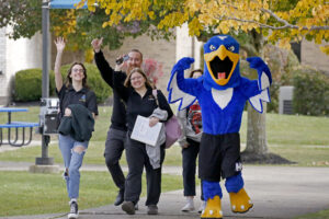 Hilbert campus walks around campus with Bert, our Hawk Mascot.