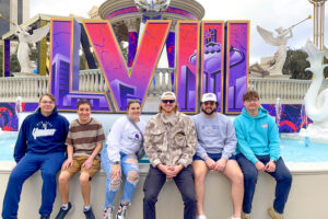 Students posing outside of Super Bowl 2024.