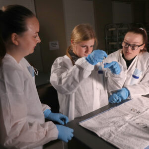 Hilbert students working on evidence bags.