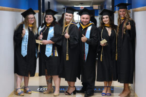 Hilbert students ready ot graduate, posing for the camera.