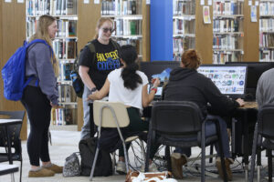 Hilbert students chatting in the library.