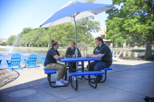 Students talking next to the Hilbert pond.