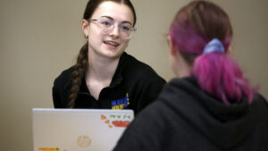 Students talking to each other in class at Hilbert