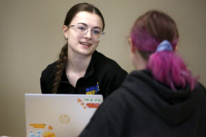 Students talking to each other in class at Hilbert