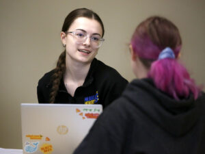 Students talking to each other in class at Hilbert