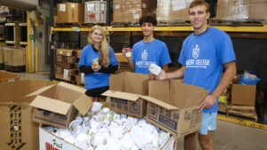 Hilbert students sorting food at FeedMore of WNY.