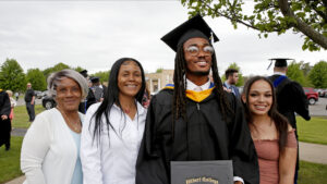 Hilbert College graduate posing with his family
