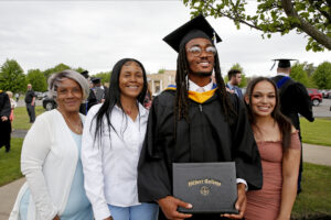 Hilbert College graduate posing with his family