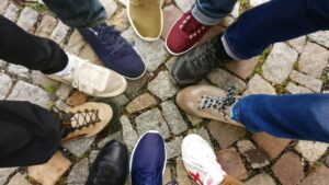 Shoes from all different types of people in a circle.