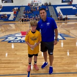 Hilbert's Rob DeGrandpre posing with e summer camp participant.