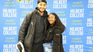 Two students pose at Hilbert College's Graduate Fair.